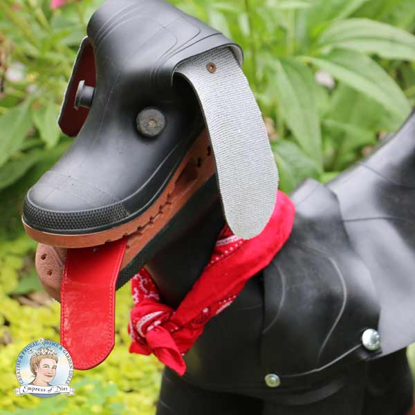 Rubber boot dog with red belt for tongue. 