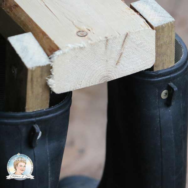 Close up of wood frame for boot dogs. 